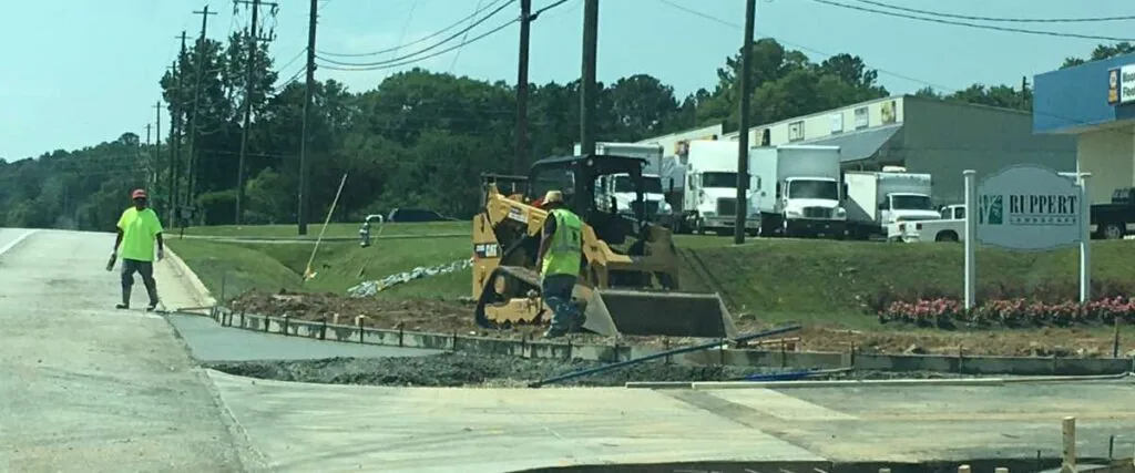 pks paving employees working on the shoulder of a road