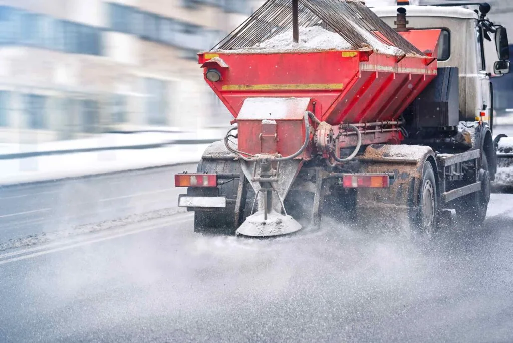 truck spreading de-icing salt on road