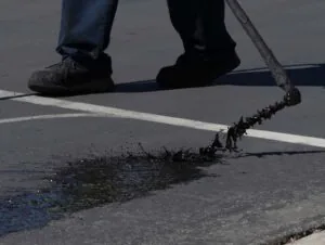 person laying down sealcoat