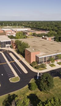 Educational-Facilities-2.png aerial view of a school and parking lot