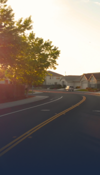 municipalities.png curvy road with houses in the background